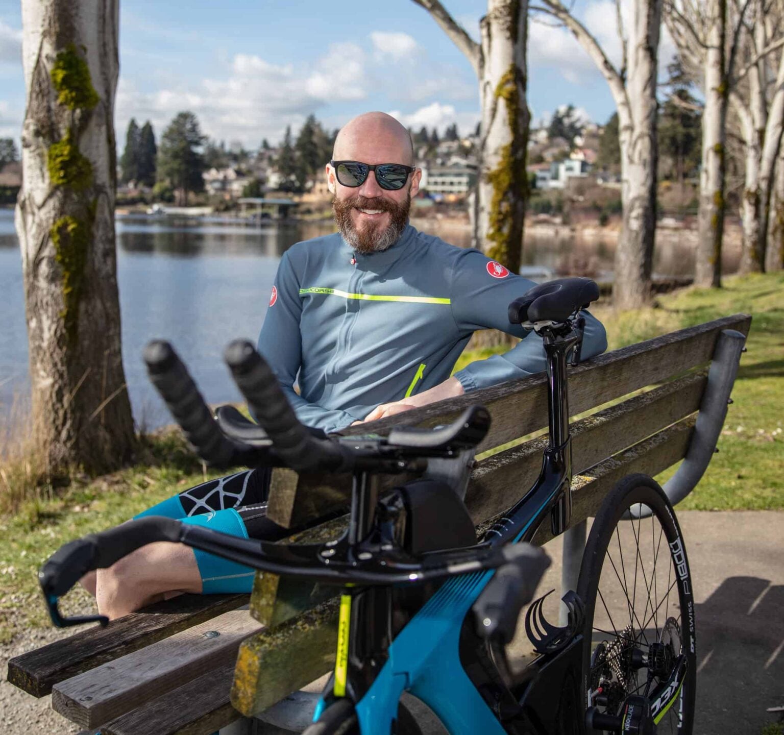 Chris Johnson sitting on a bench with his triathlon bike